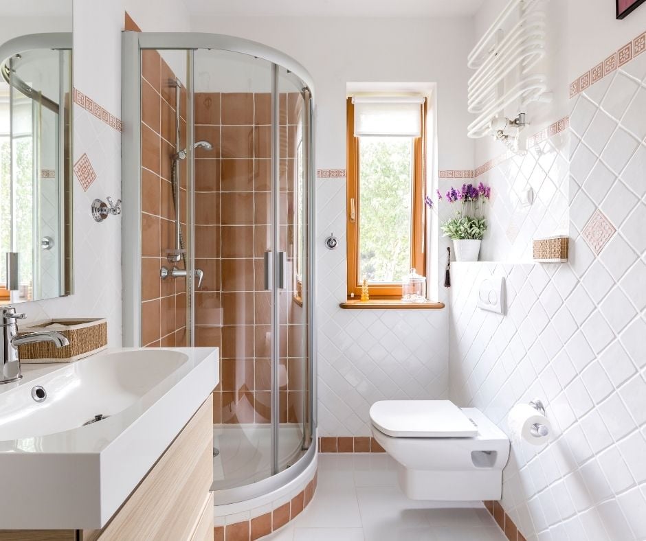 Bright and clean modern bathroom with a built-in toliet and glass shower