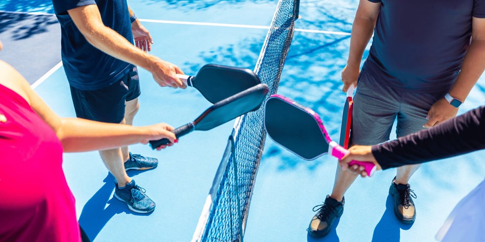 Stock Image of Four People at a Pickleball Net