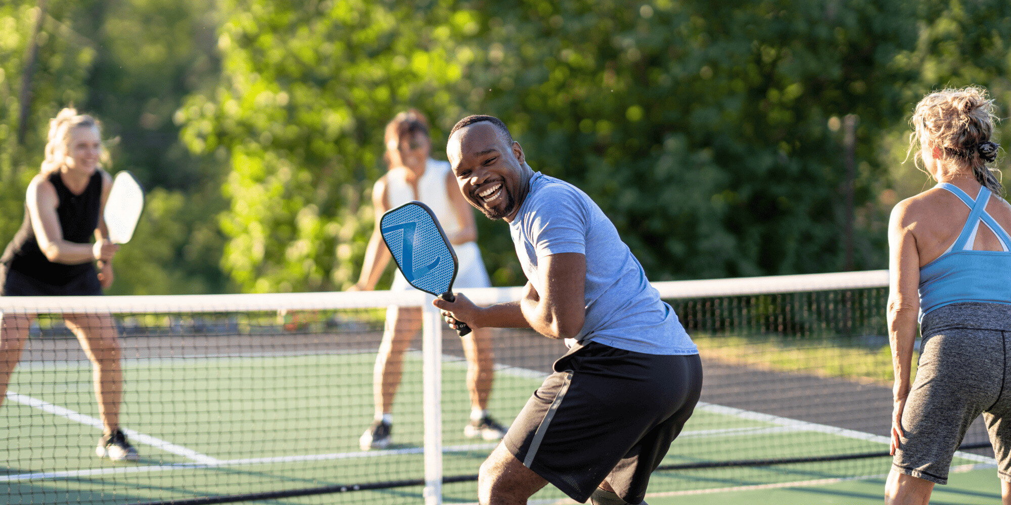 Stock Image of Four People Playing Pickleball