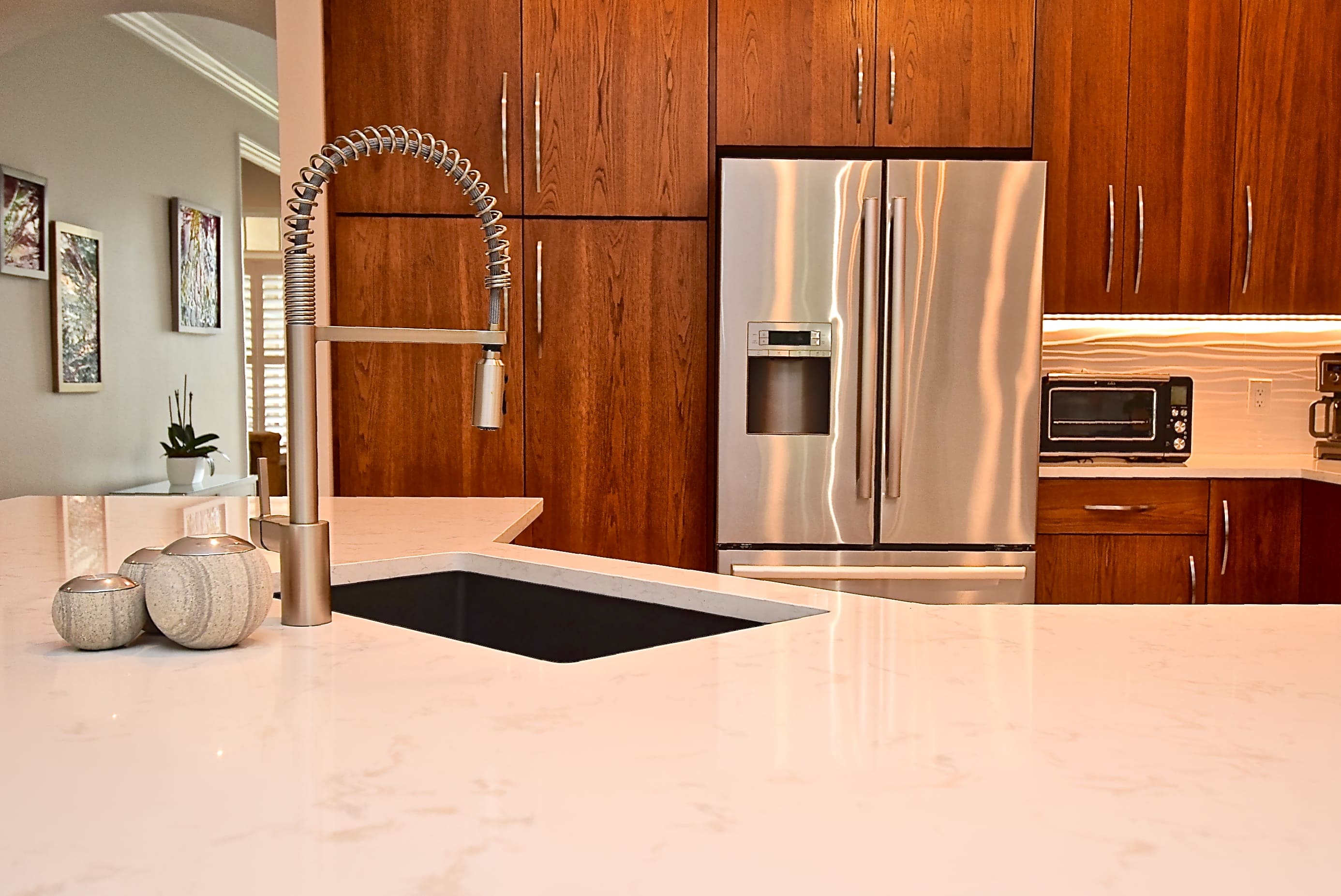 Stainless Steel Appliances in Midcentury Modern Kitchen Remodel in Sarasota with Warm Natural Wood Cabinets 