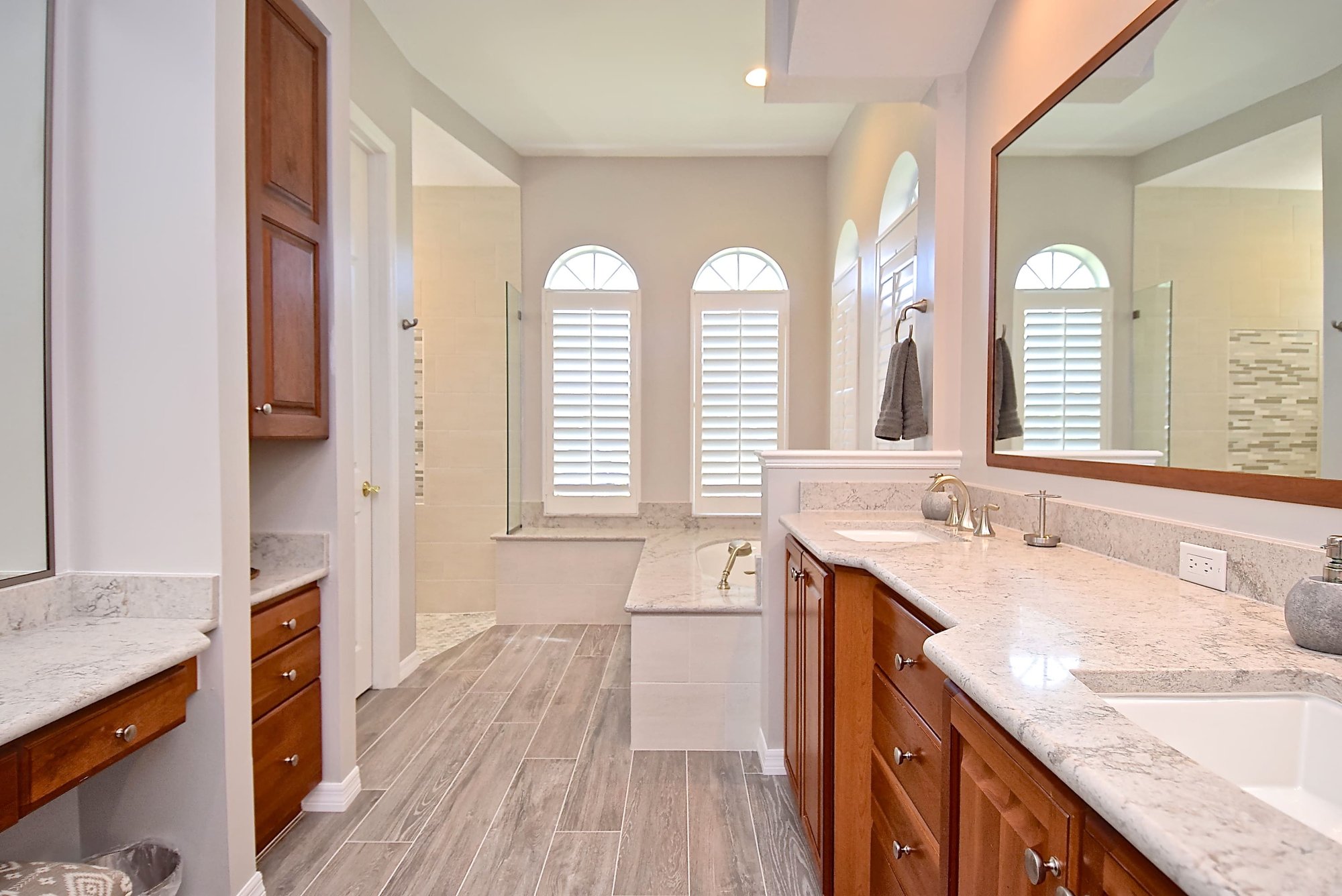 Primary Bathroom with Storage and Double Vanity and Large Mirror and Walk in ADA Shower in Sarasota Primary Bathroom with Storage and Double Vanity and Large Mirror and Walk in ADA Shower in Sarasota