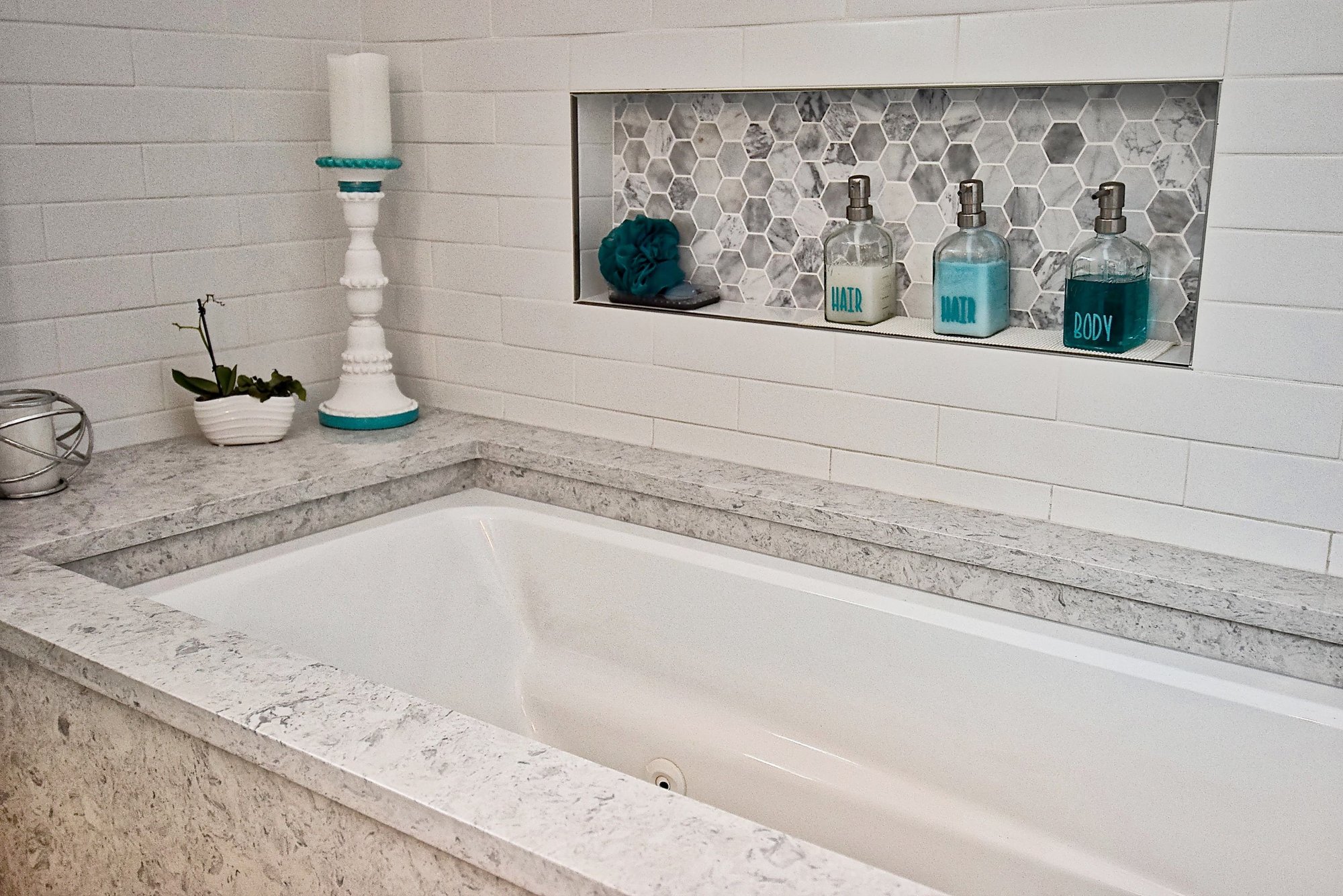 Built In Soaking Tub with Custom Inset Niche with Mosaic Hex Acccent Tile in Remodeled Sarasota Bathroom