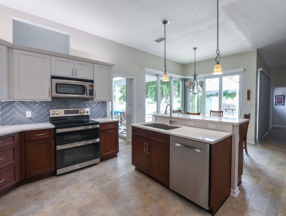 Modern Kitchen Remodel with Sink In The Island and Raised Breakfast Bar