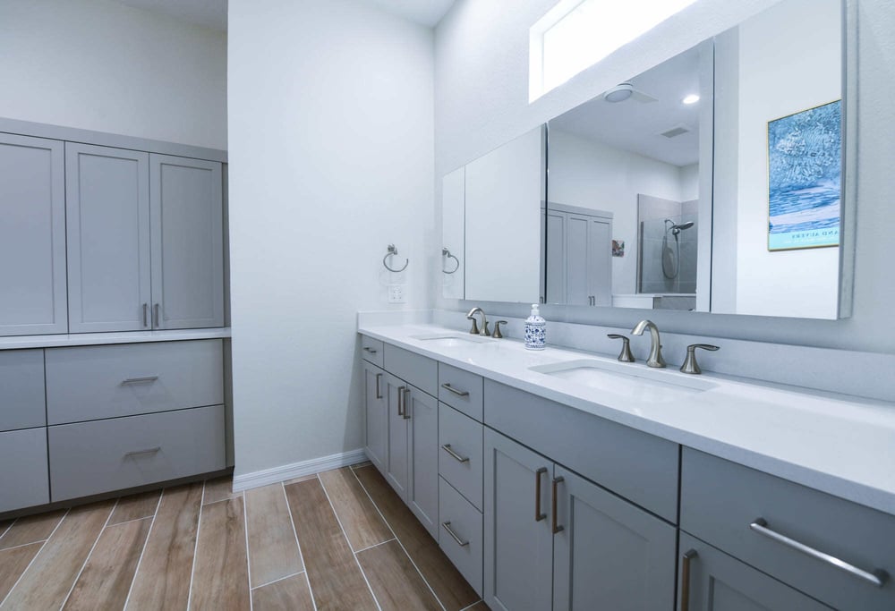 Luxury Bathroom Remodel with Blue Vanities and Custom Storage