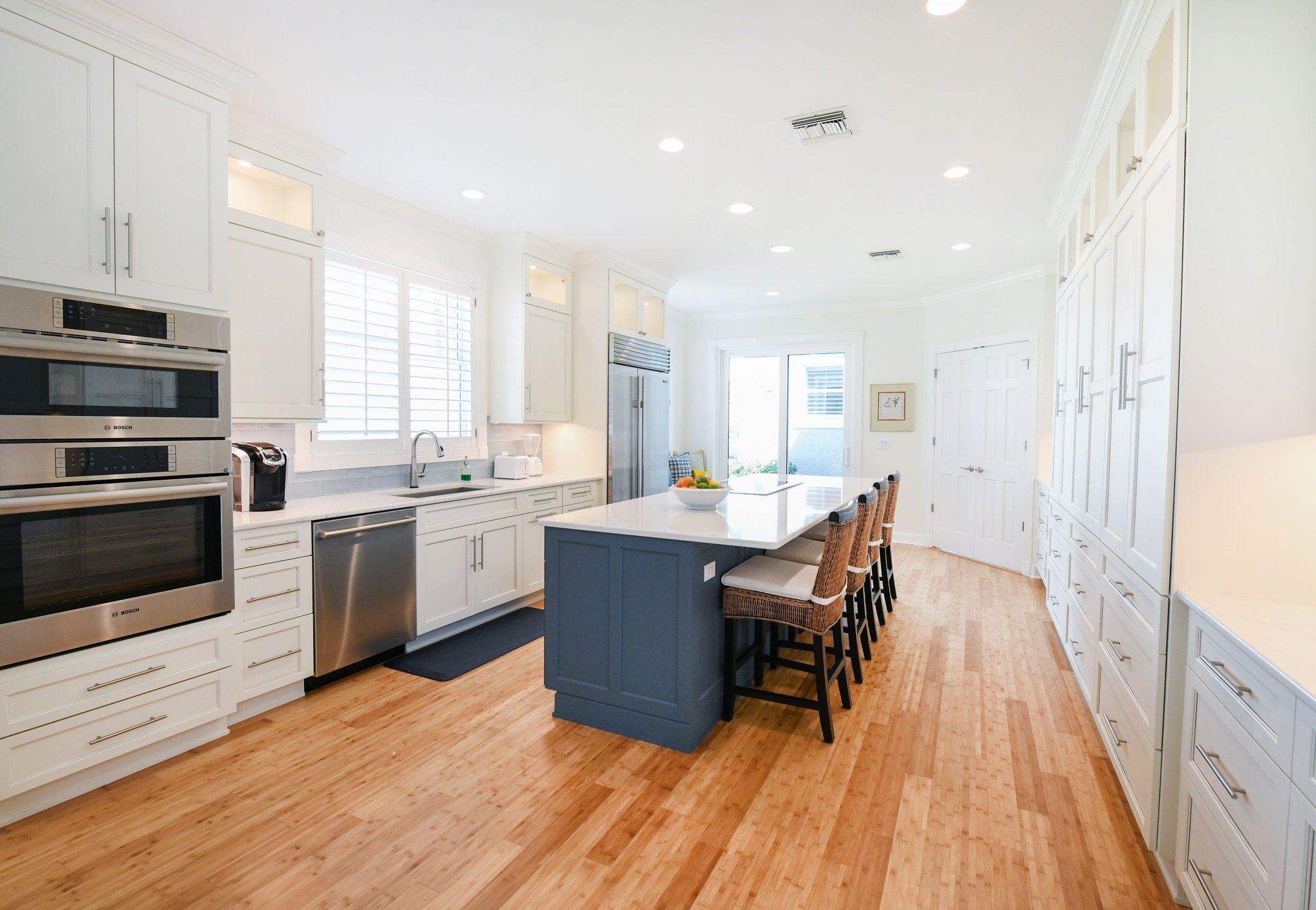 White Kitchen Cabinets with Blue Island and White Countertops in Sarasota Kitchen Renovation