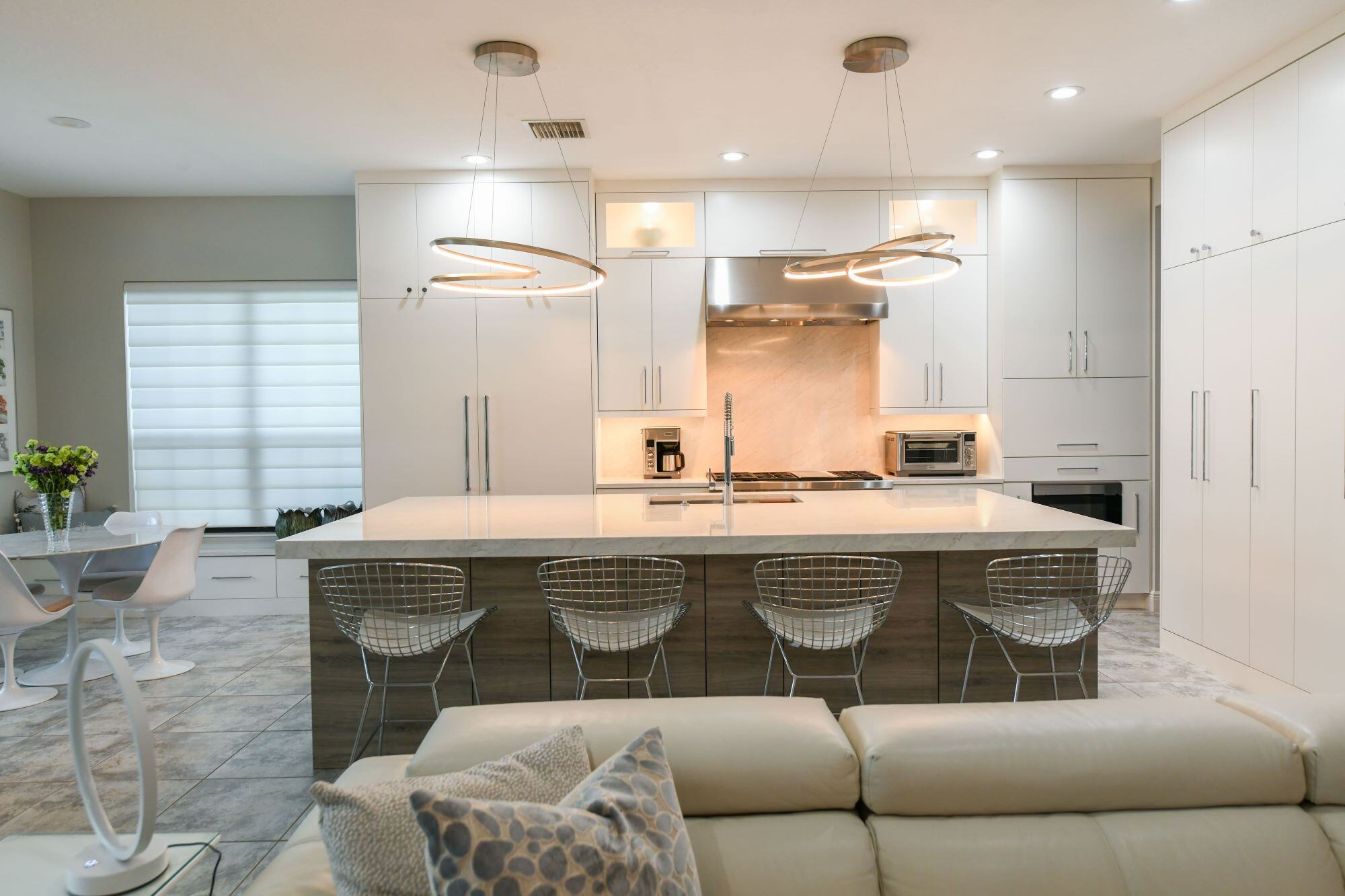 Open Concept White Kitchen with Island Seating in Sarasota Remodel