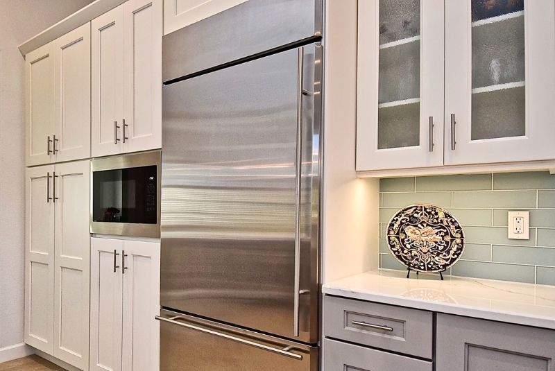 stainless steel and white cabinets in modern kitchen remodel