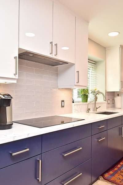Two-tone cabinet refresh with navy lowers and white uppers in modern kitchen by Gilbert Express
