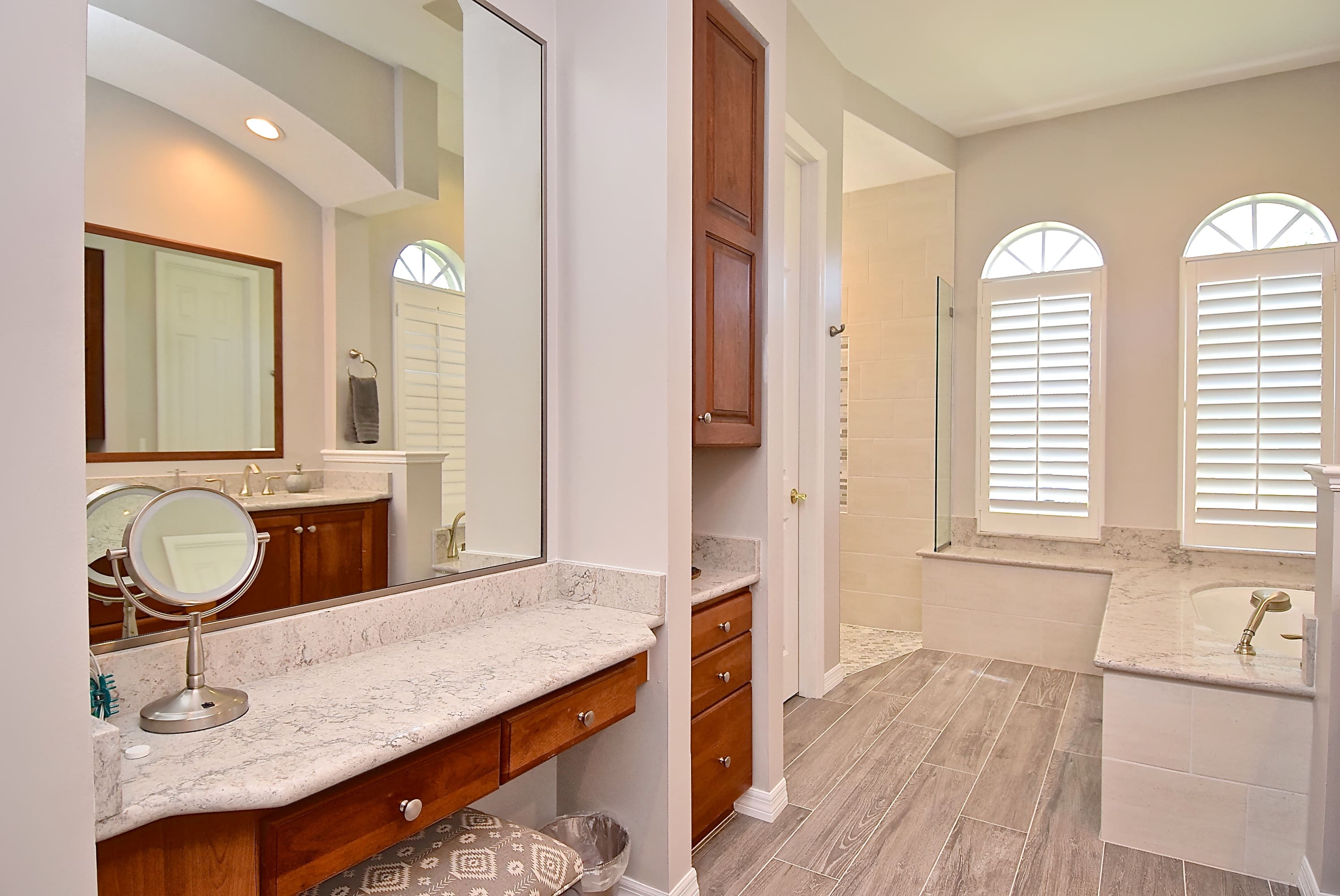 Primary Bathroom with Vanity for Makeup and Soaking Tub Windows in Sarasota Remodel 