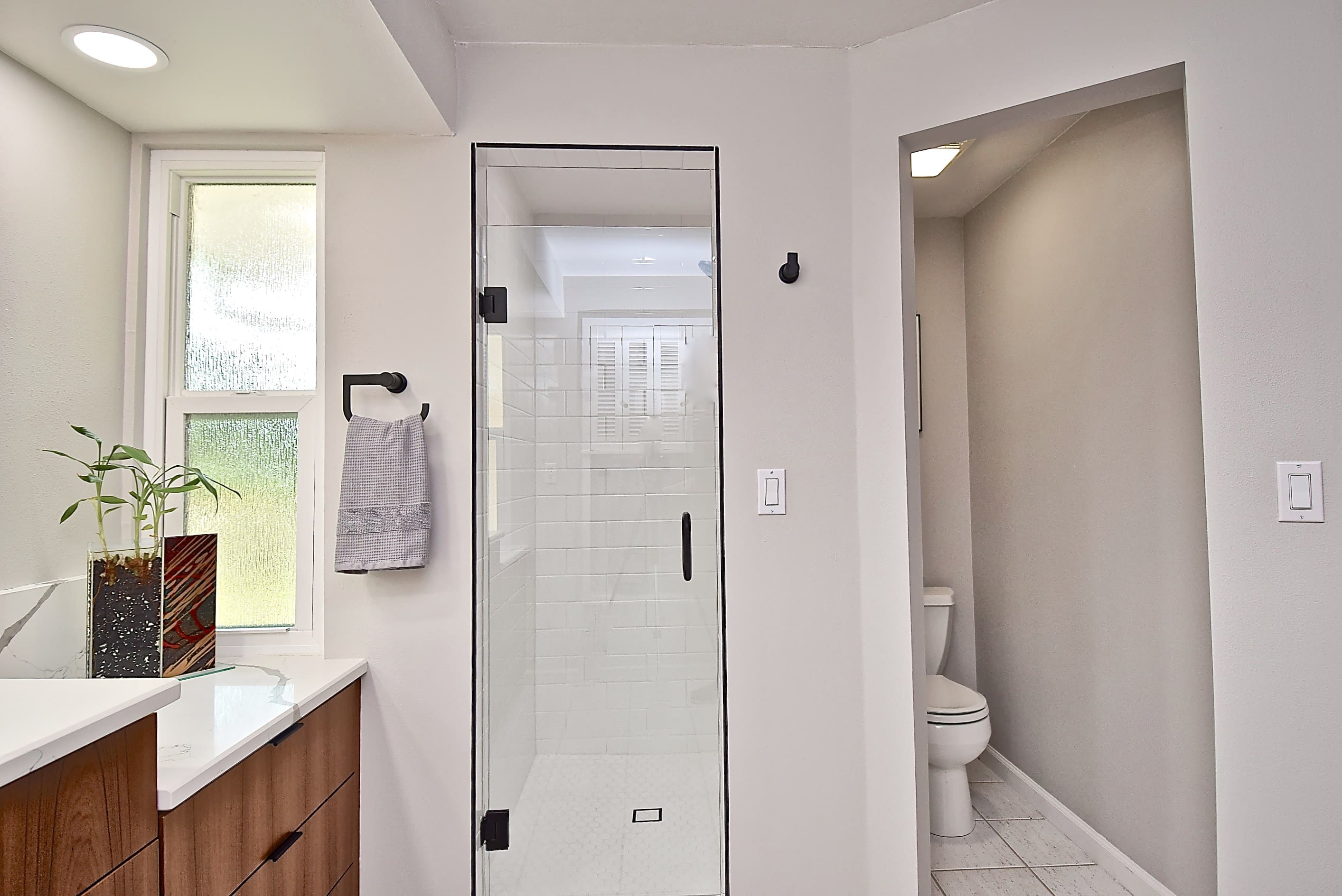 Sleek Modern Bathroom Remodel with Toilet Room in Sarasota with Wood Cabinets