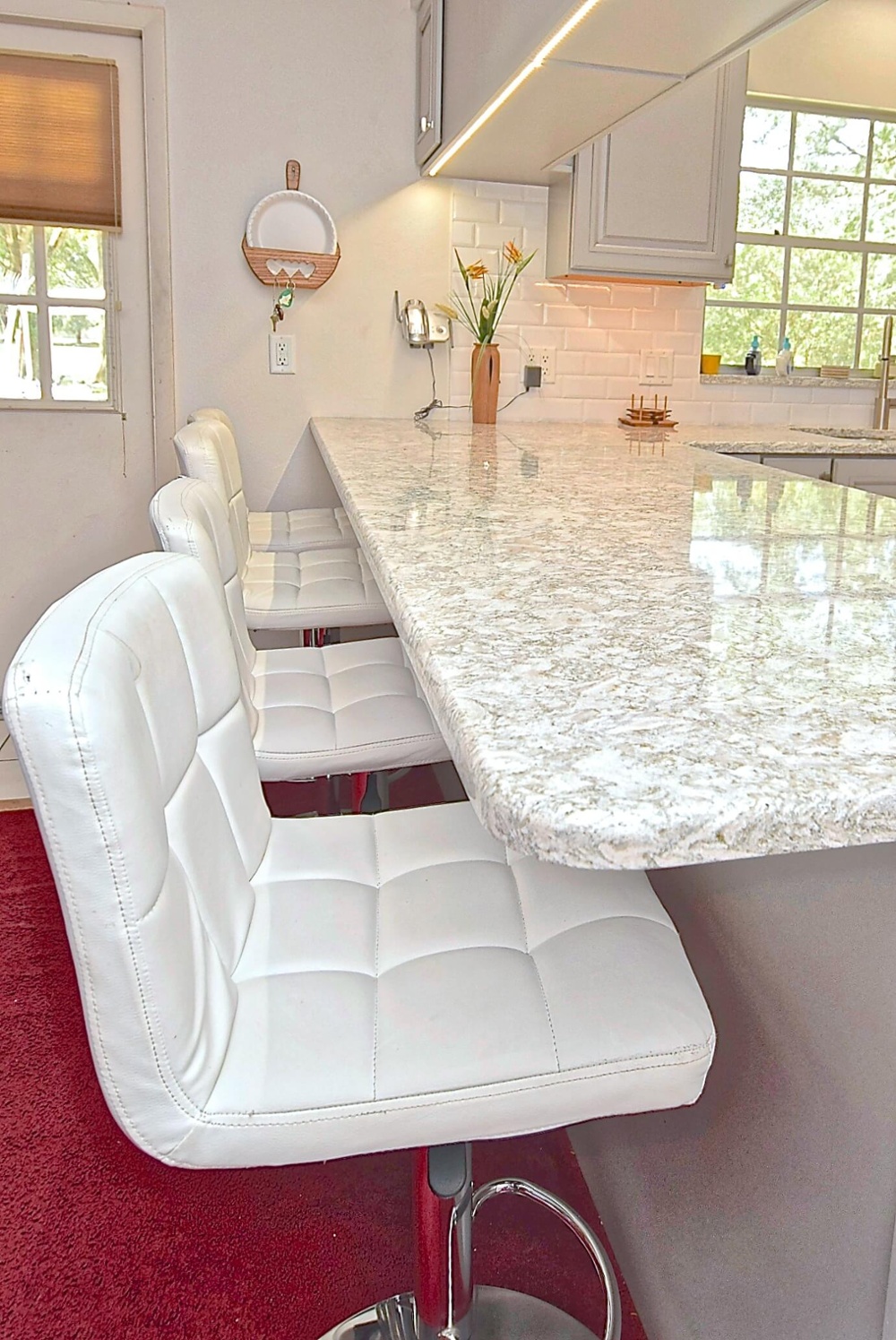 White bar stools with gray and white countertop