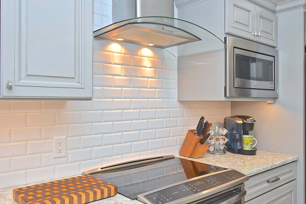 glass range hood in gray kitchen remodel