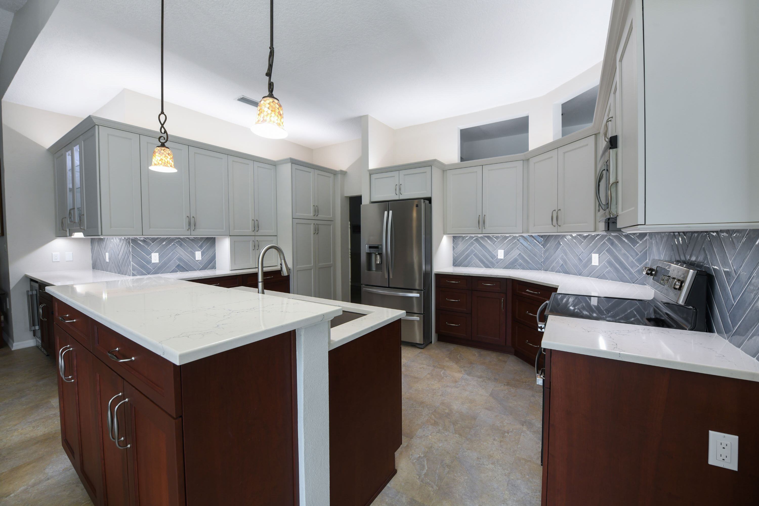 Cherry Lower Cabinets and Warm Gray Upper Cabinets in Kitchen Remodel in Sarasota