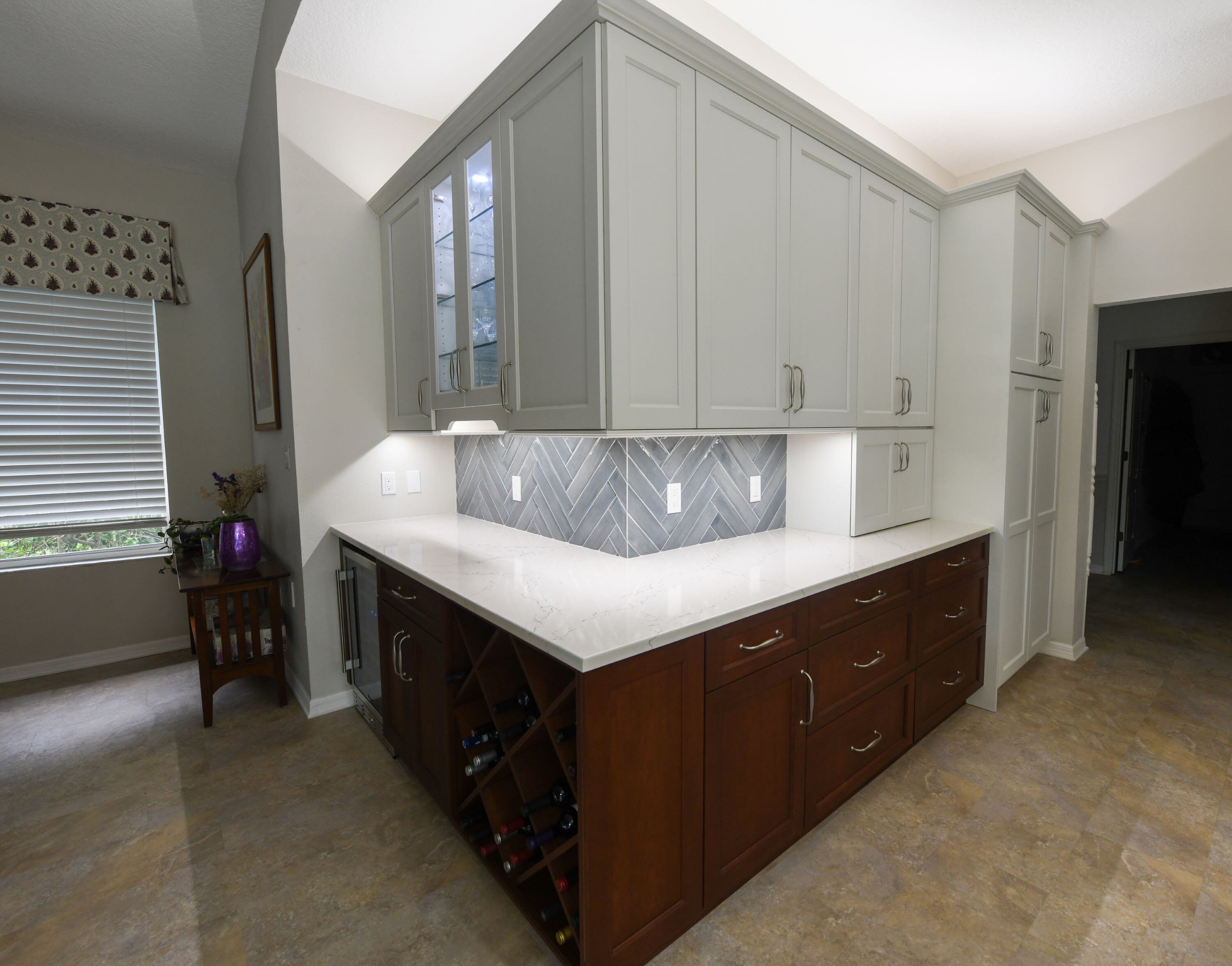 Modern Kitchen Renovation in Sarasota Area with Custom Wine Rack Built In and Blue Herringbone Backsplash Tile