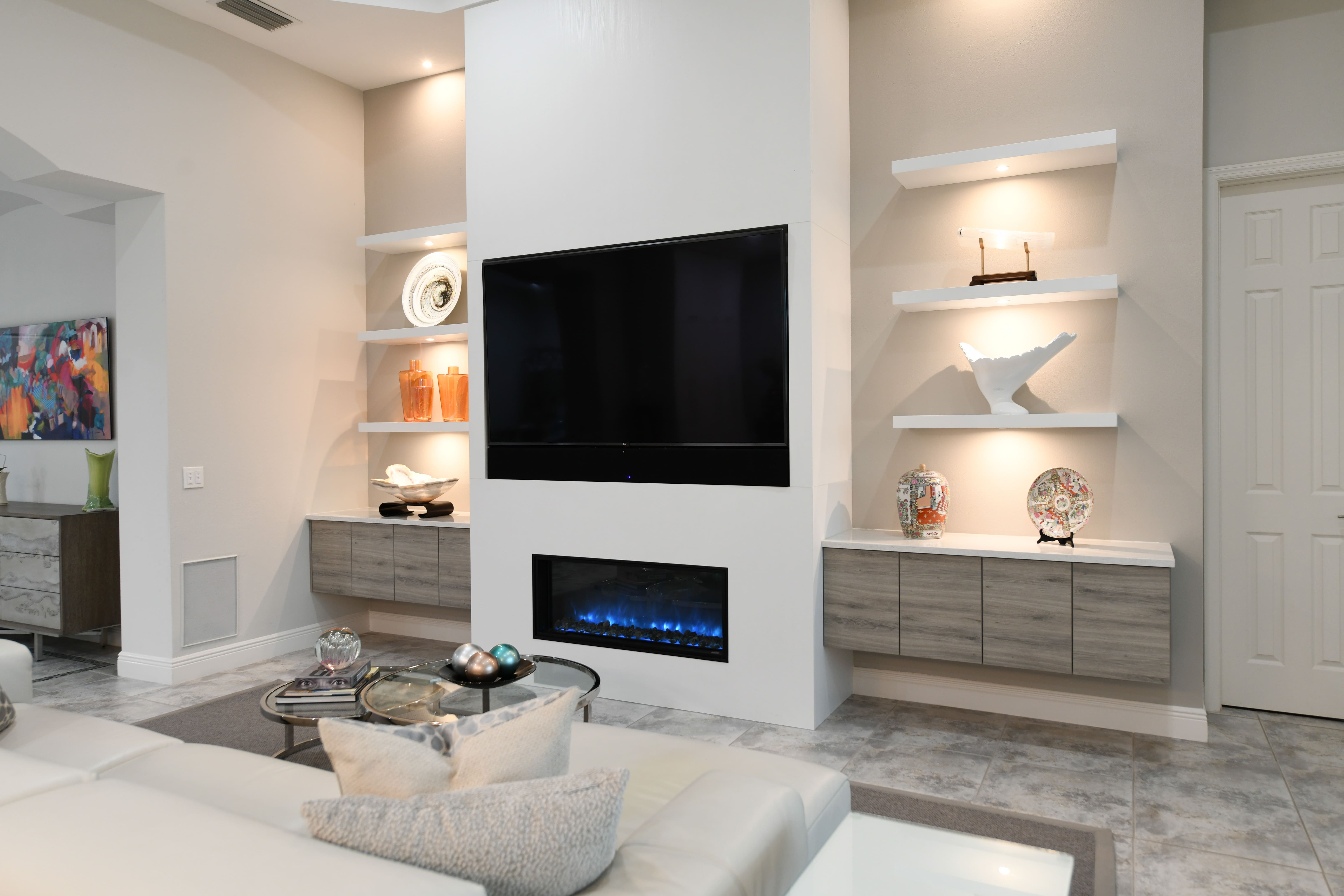 Modern Fireplace Feature Wall with Floating Storage and Open Shelving in Sarasota Remodel