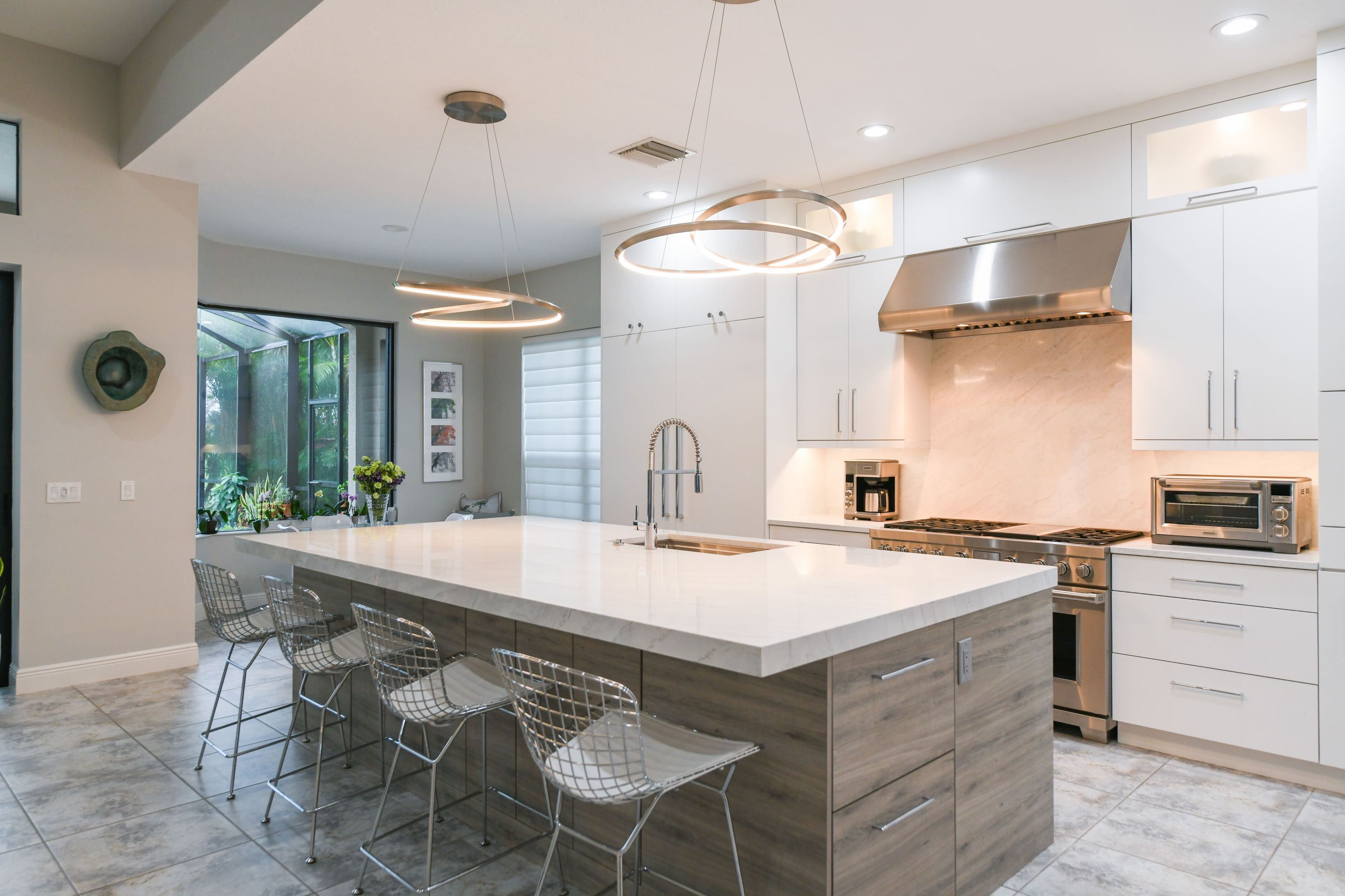 Island with Sink and Sculptural Pendant Lighting in Modern Sarasota Kitchen Remodel